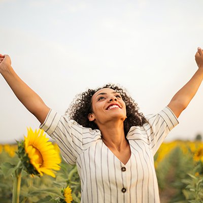 Photo Of Woman Standing On Sunflower Field